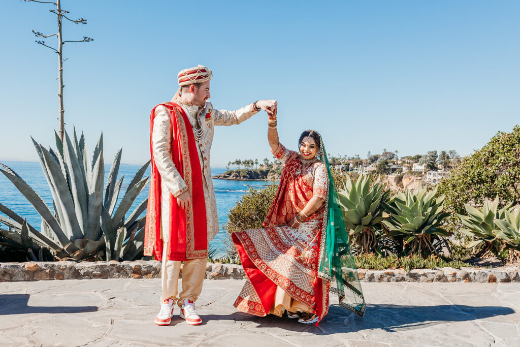 Groom spinning Indian bride after first look at Laguna Beach