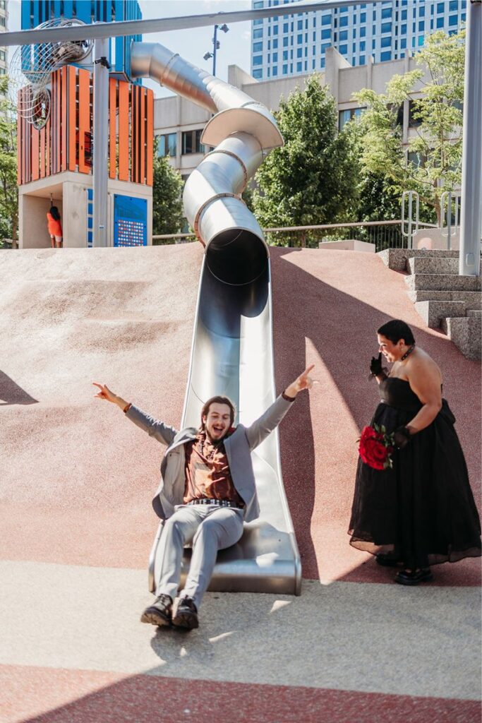 Clint sliding down after their Boston city hall elopement 