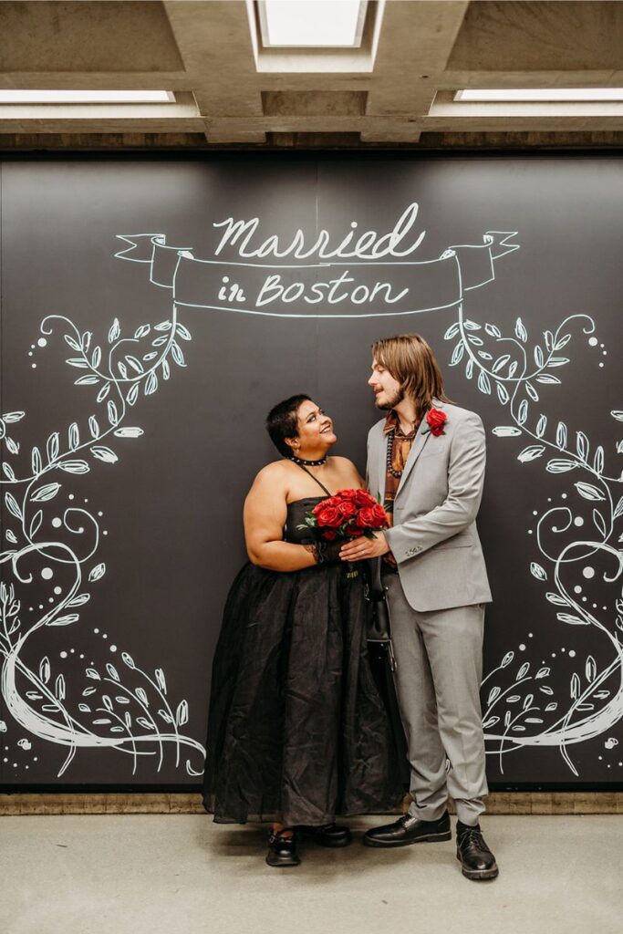 a couple posing after their Boston city hall elopement 