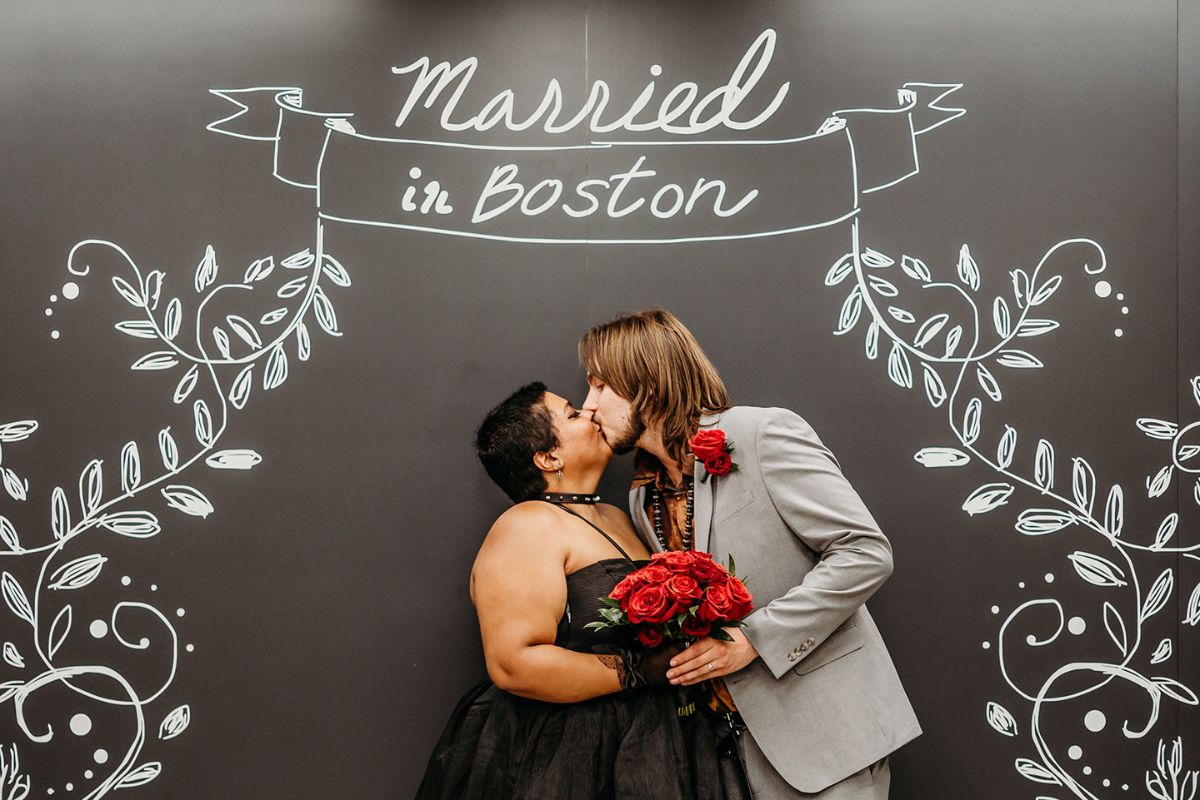 A couple kissing after their Boston city hall elopement