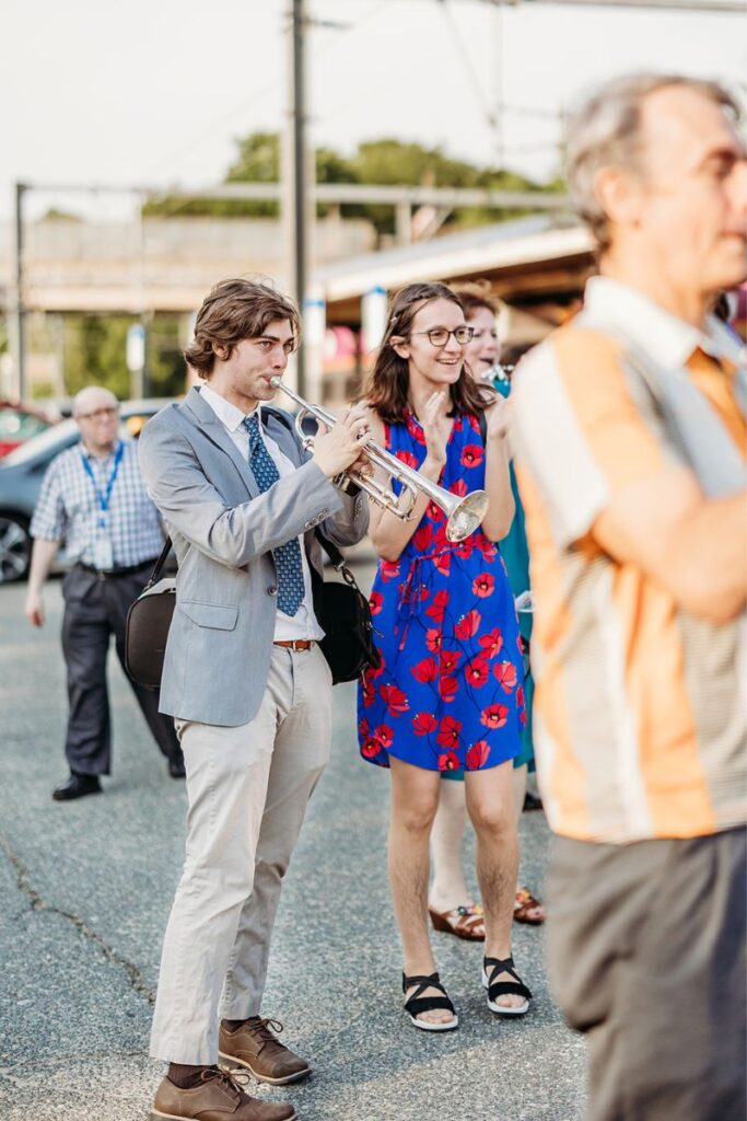 a guest playing trumpet to celebrate their Boston city hall elopement 