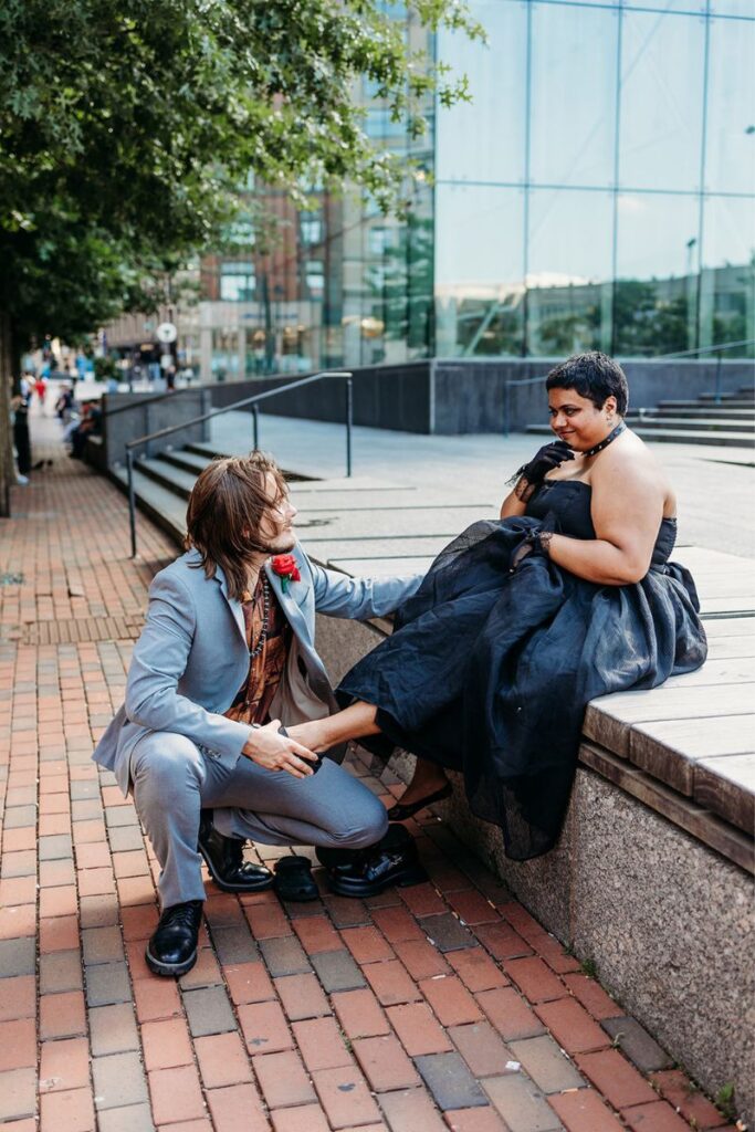 Clint helping Tara change their shoes after their Boston city hall elopement 