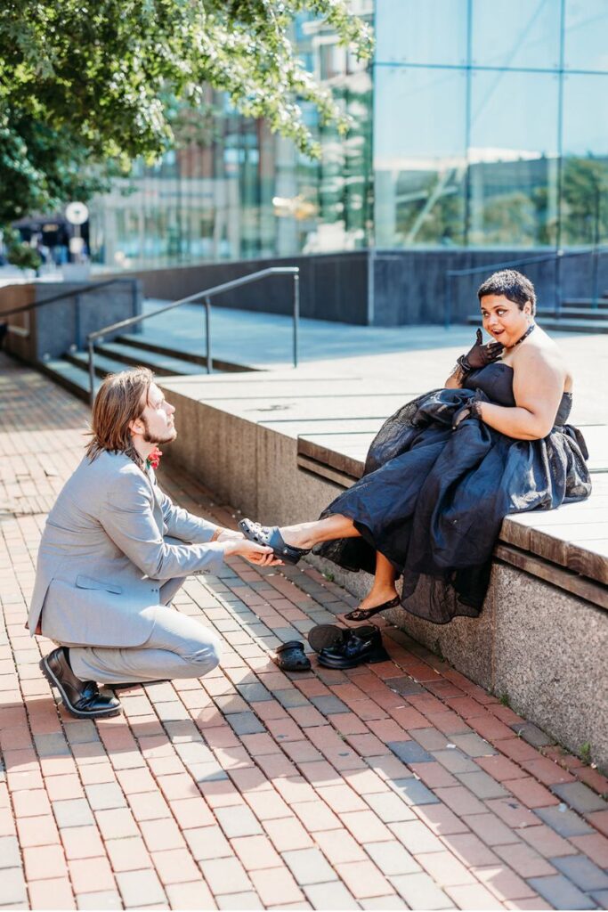 Clint holding Tara's foot in a romantic way 