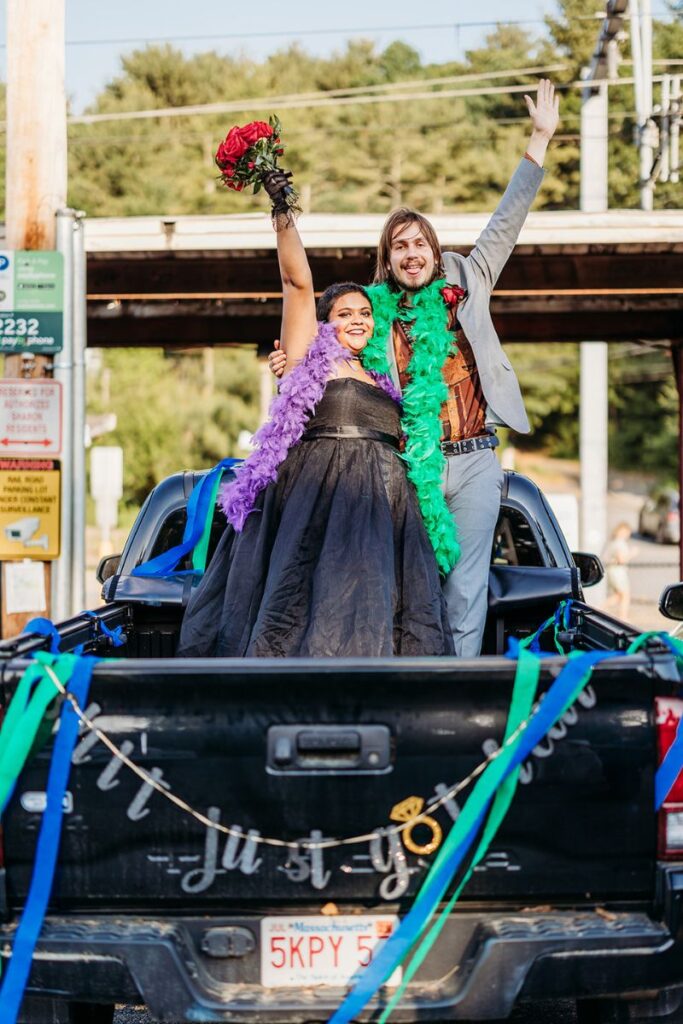 Happy couple in a pick up car going to their Boston city hall elopement party