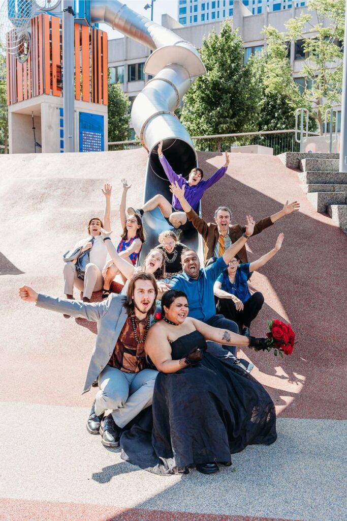 the entire wedding party cheering on a slide 