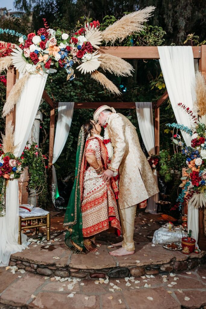 a couple having their first kiss as married