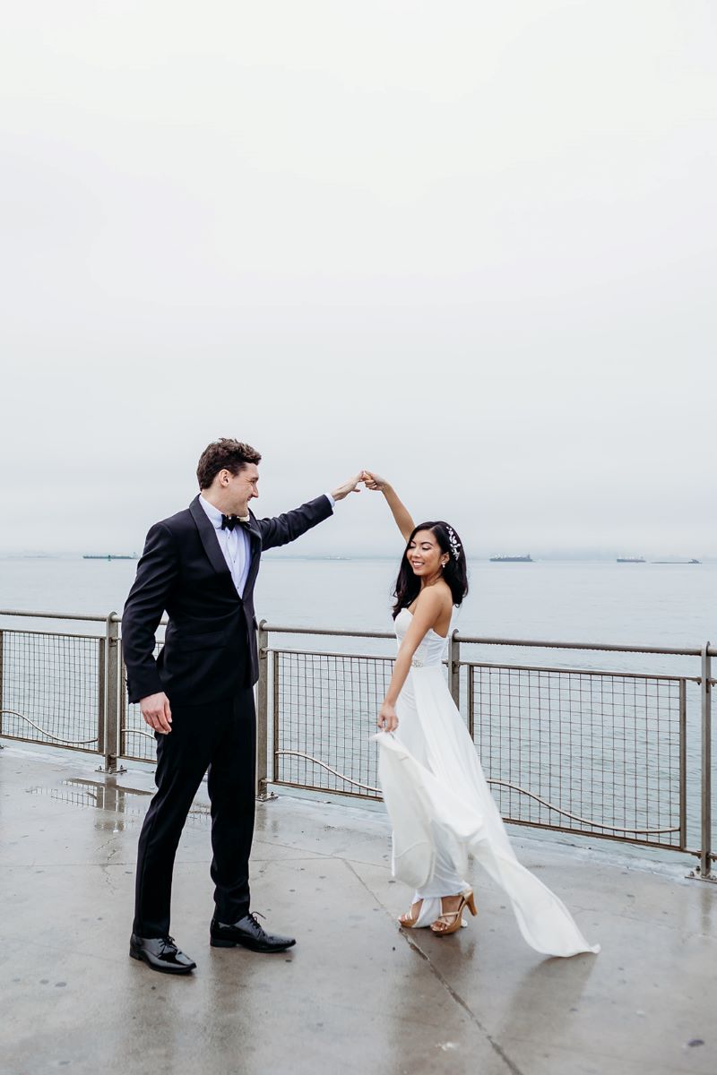 man in a suit spinng a woman in a wedding dress 