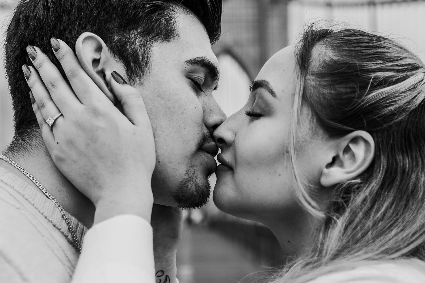 black and white photo of a couple leaning in to kiss each other 