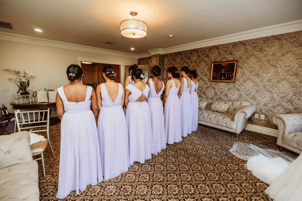 A GIF of bridesmaids turning around and smiling 