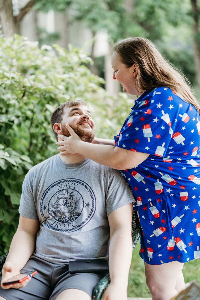 A person touching their partner's face as they look up at them 
