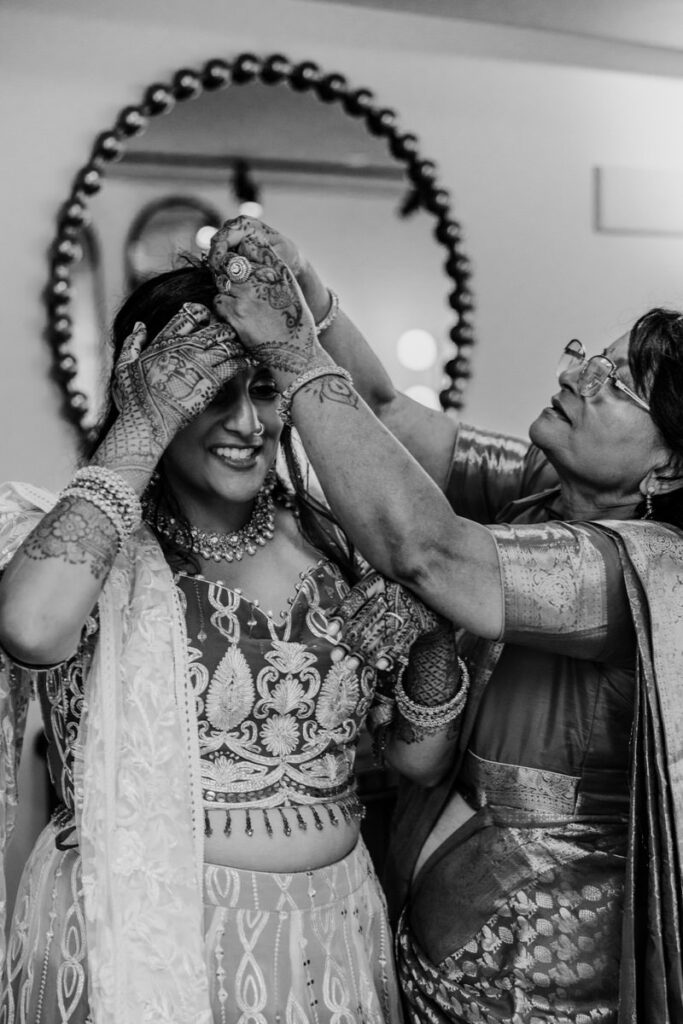 A person helping a bride with her hair 